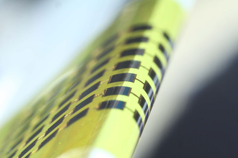 Ultra-thin solar cells are flexible enough to bend around small objects, such as the 1mm-thick edge of a glass slide, as shown here. <br/>CREDIT: Juho Kim, et al/APL Ultra-thin solar cells are flexible enough to bend around small objects, such as the 1mm-thick edge of a glass slide, as shown here. Credit: Juho Kim, et al/ APL