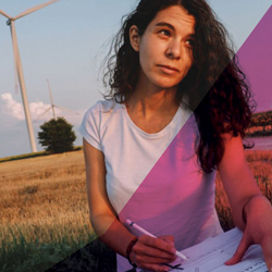 Image of a women sitting in a field writing in a notebook